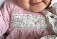Baby girls pink smocked baby grow