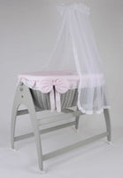 Miranda Quattro. Grey basket . Pink bedding .cot .